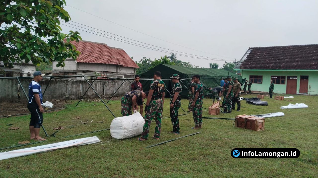 Foto : Personel Babinsa Kodim 0812 Lamongan dan prajurit Yonif TP 887KJM bahu-membahu membersihkan lahan dan memasang tenda di Marshalling Area Ngimbang.
