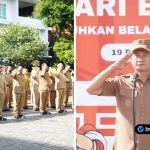 Foto : Bupati Lamongan Yuhronur Efendi berdiri di podium memberikan amanat pada Apel Peringatan Hari Bela Negara ke-77 di halaman Gedung Pemkab Lamongan.